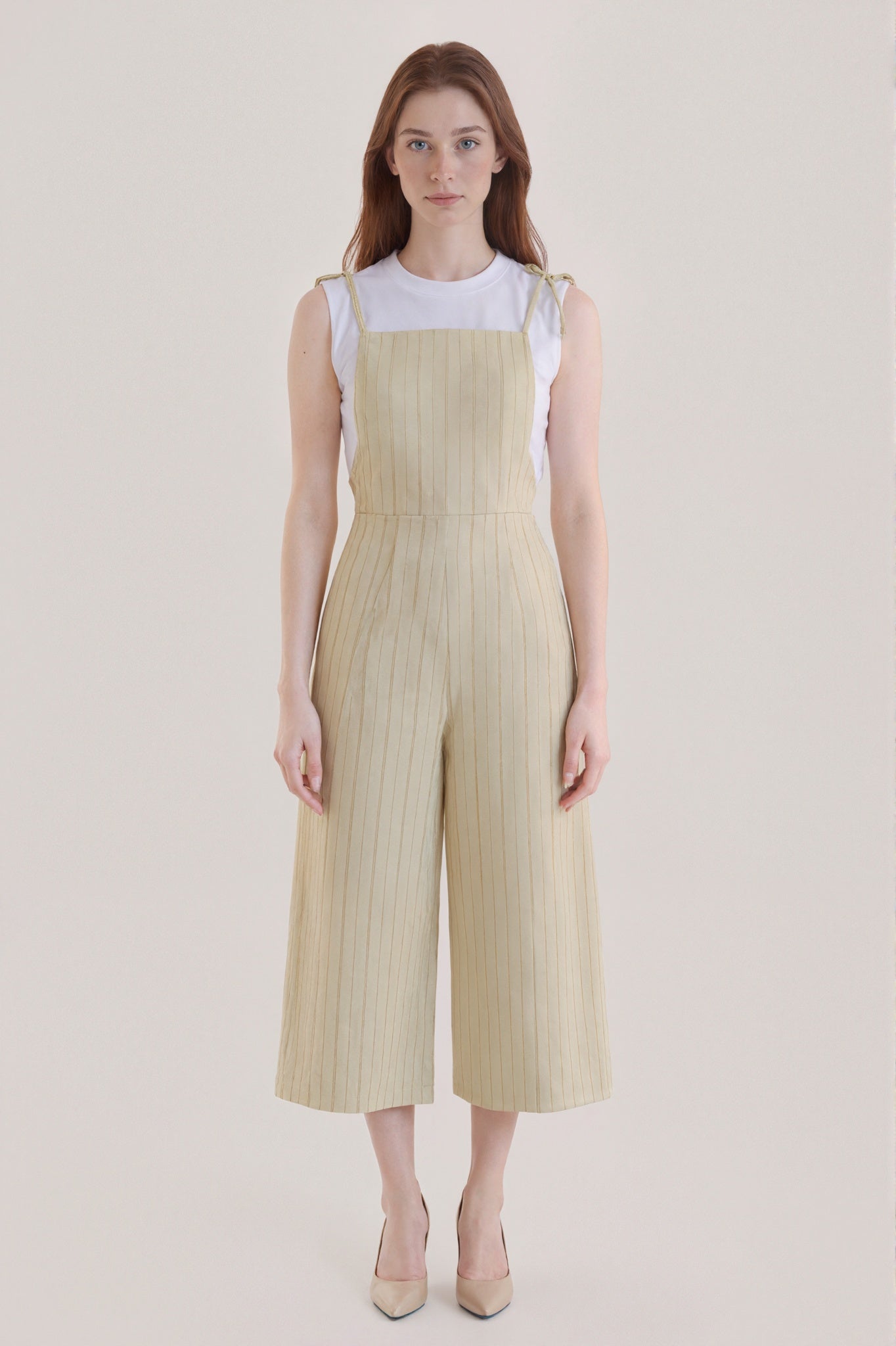 Sleeveless beige jumpsuit with subtle vertical stripes