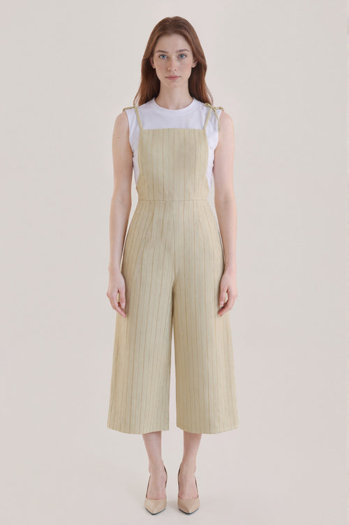 Sleeveless beige jumpsuit with subtle vertical stripes
