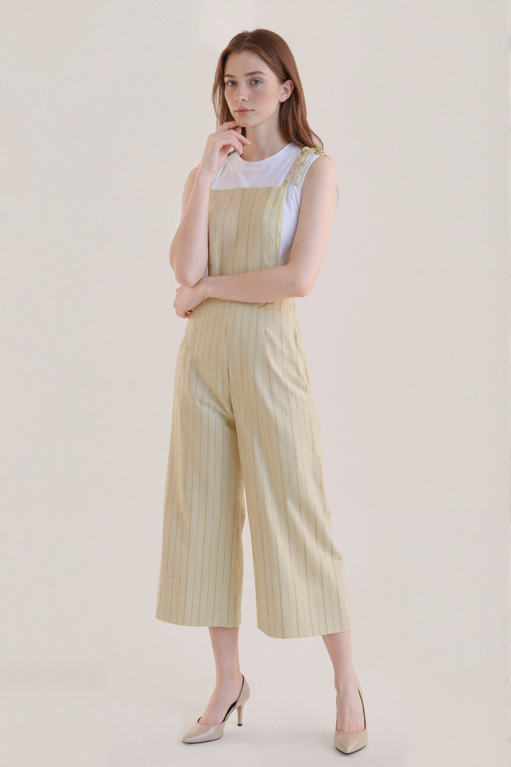 Sleeveless beige jumpsuit with subtle vertical stripes